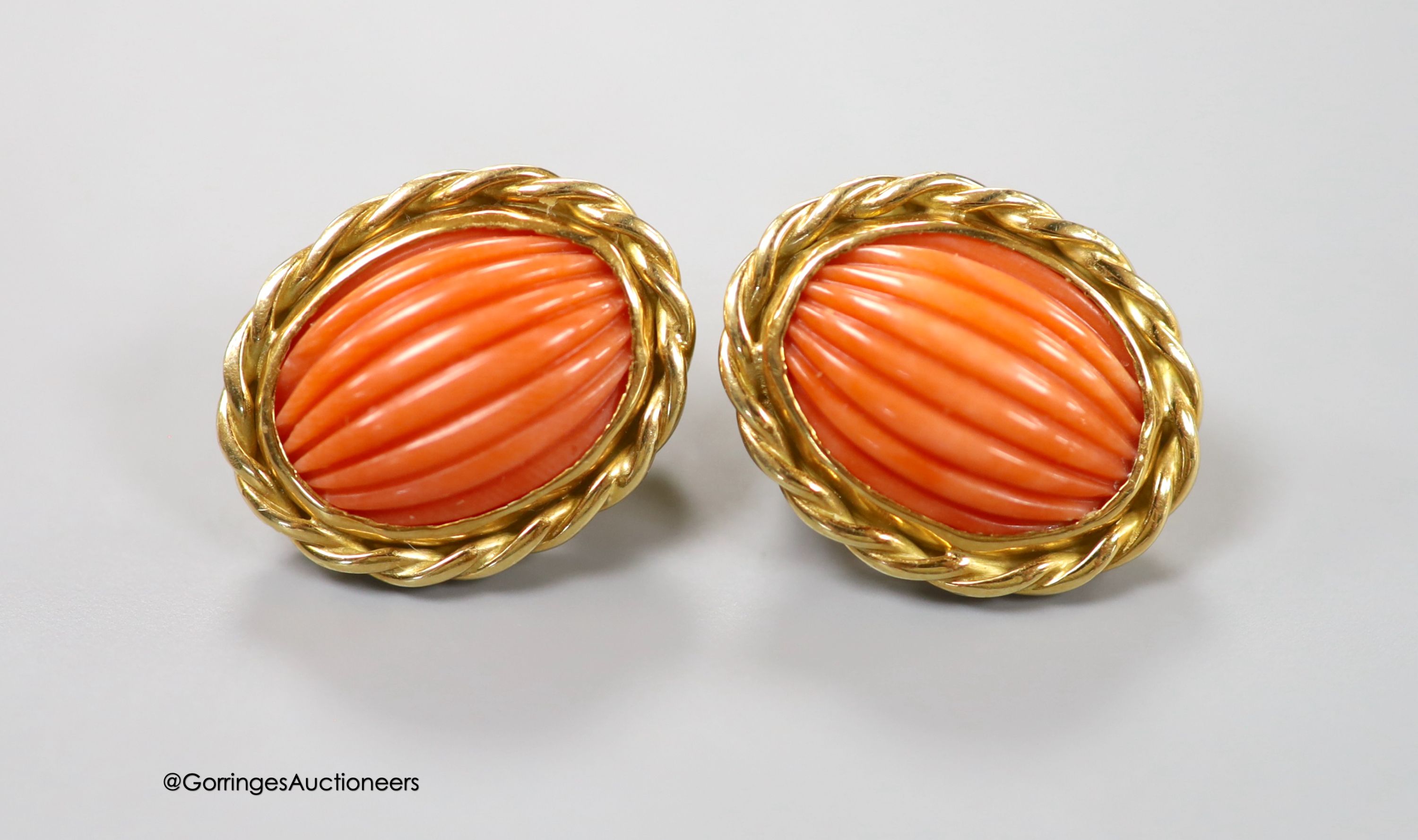A modern pair of 18ct gold and fluted oval coral bead set earrings, 20mm, gross weight 12 grams.